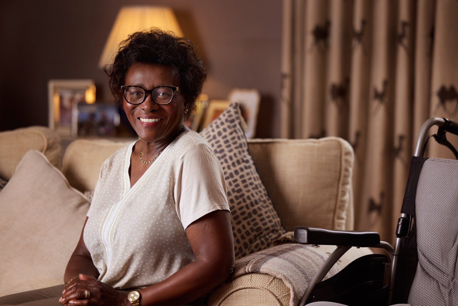 Bluebird Care: a smiling woman on her sofa at home