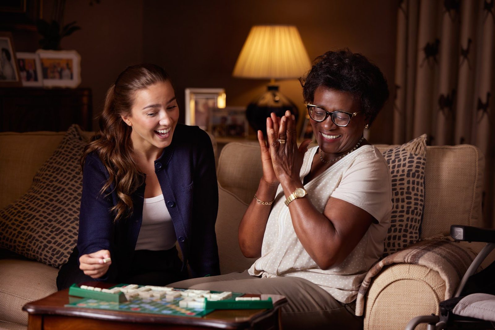 Bluebird Care: a carer and a client laughing over a board game