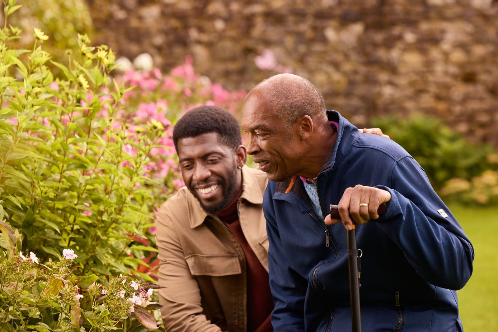 Bluebird Care: two men laughing together in a garden