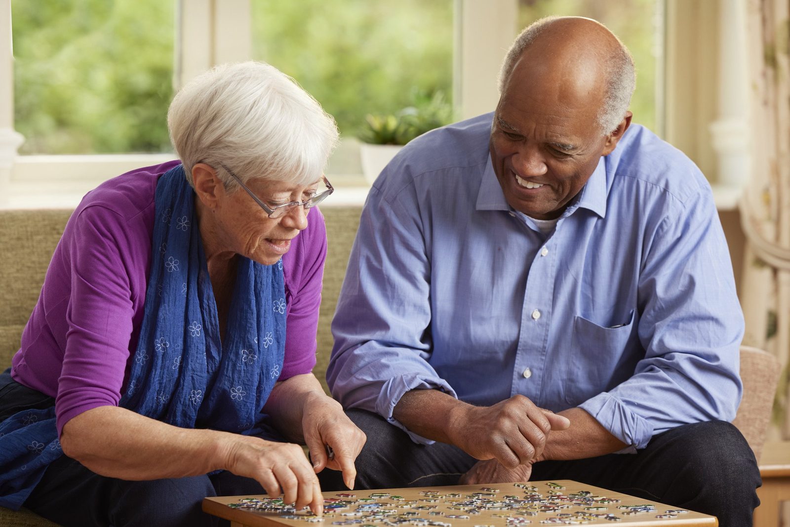 Elizabeth Finn Homes: a resident and a man doing a jigsaw together