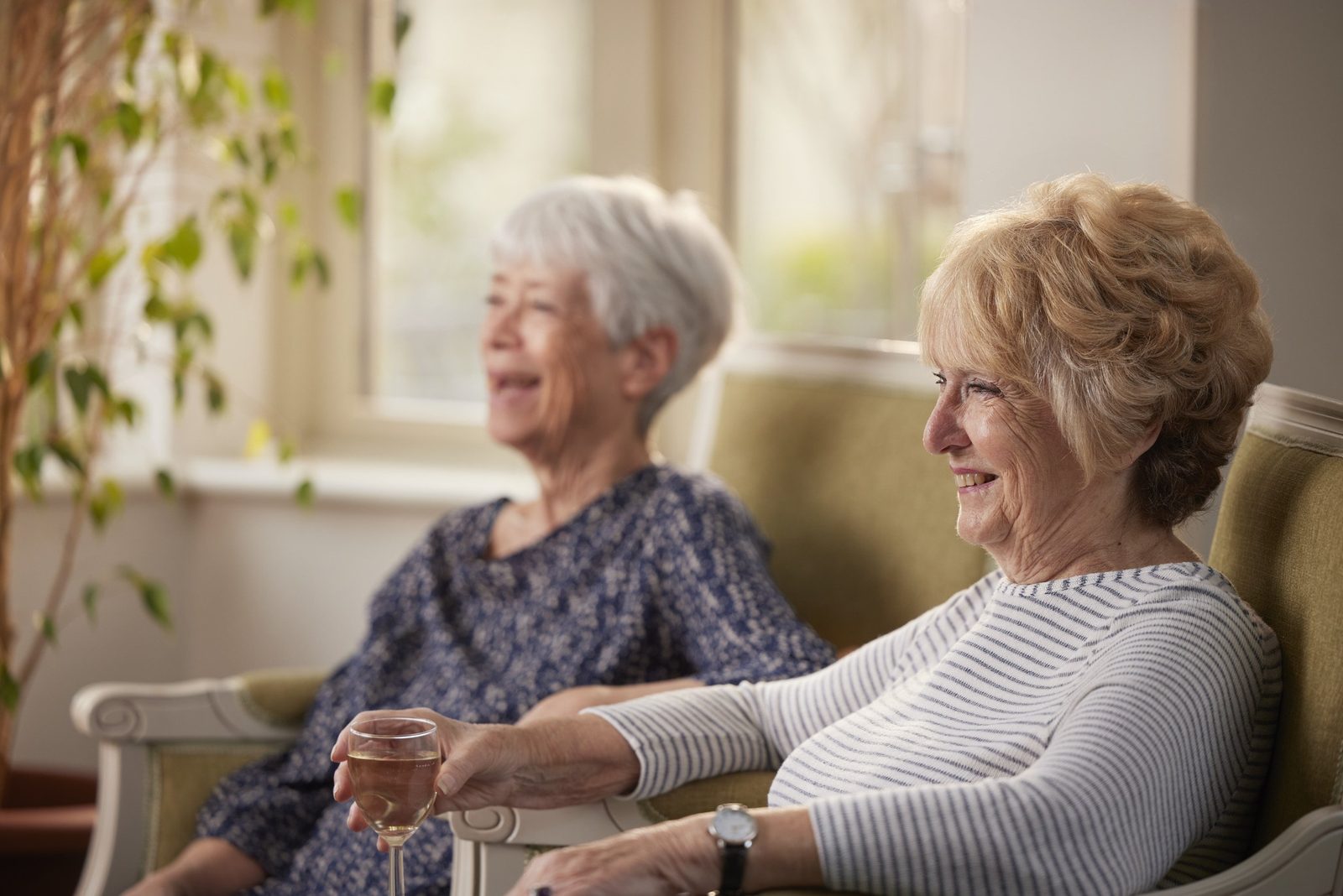 Elizabeth Finn Homes: two women laughing together in a lounge
