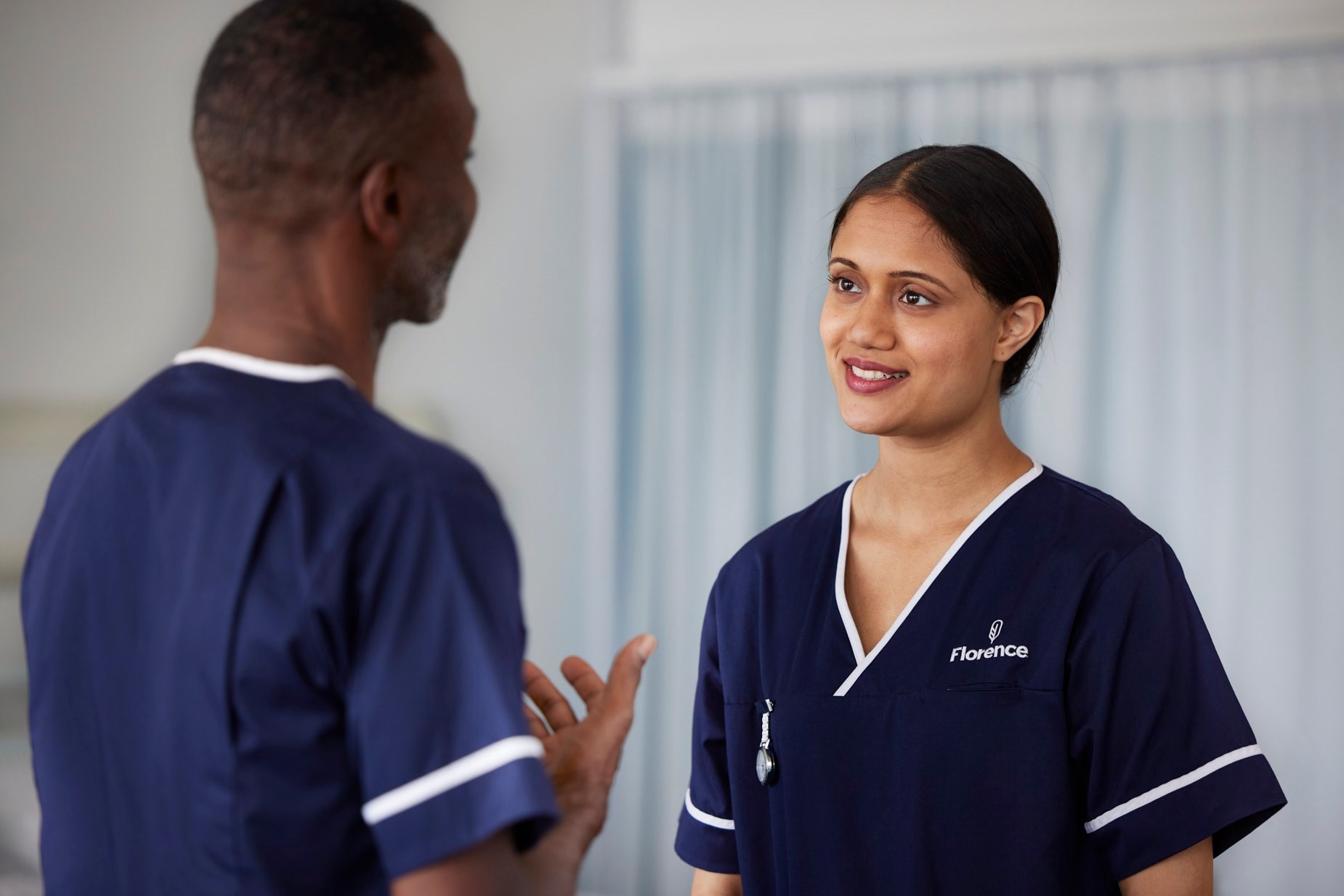 Florence: two nurses talking on a ward
