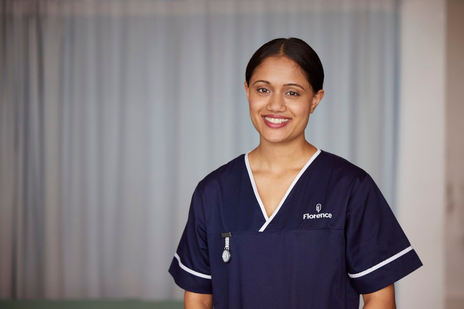 A smiling nurse in a Florence uniform